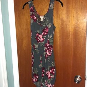 Green romper with red tropical flowers